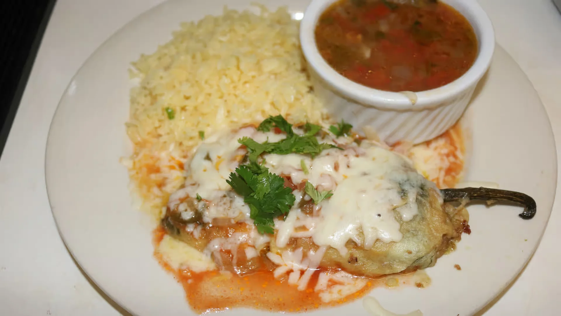 Chile Relleno Plate - Roasted poblano pepper stuffed with cheese, in tomato sauce