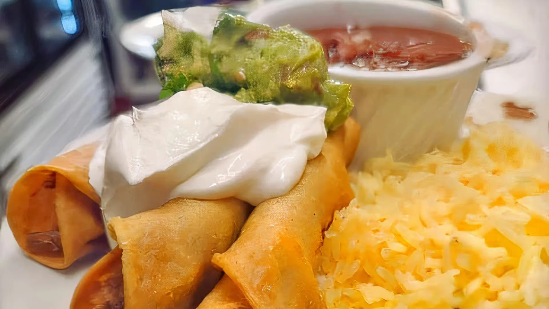 Flautas Plate - Crispy rolled tacos filled with chicken or beef, served with guacamole
