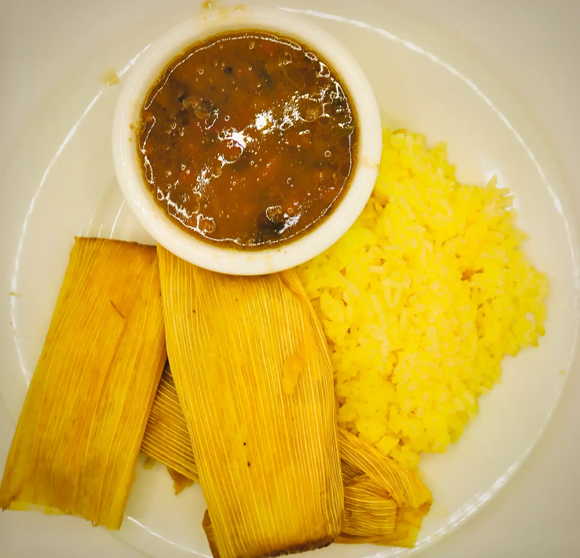 Tamale Plate - Traditional tamales made with masa and seasoned filling, wrapped in corn husks